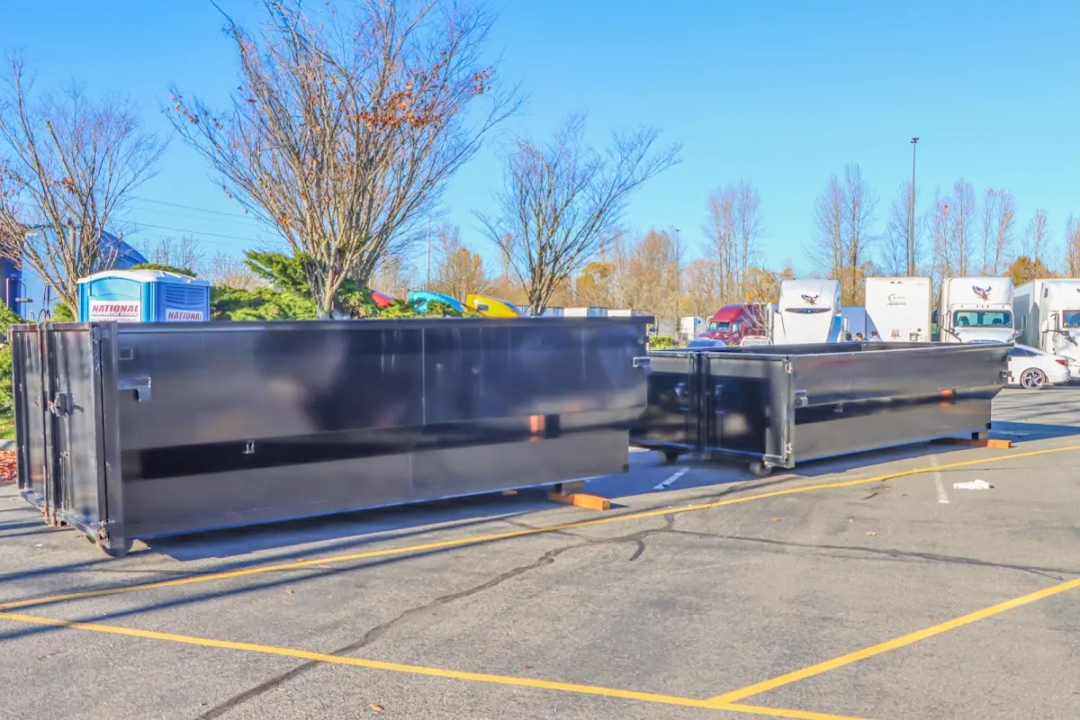 Professional dumpster rental service with roll-off container on residential driveway in Elk Ridge